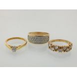 An 18ct gold and diamond ring sold together with two 9ct gold and white stone rings. (3)