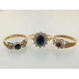 An 18ct gold, blue and white stone ring, a 9ct gold red and white stone cluster ring, and another