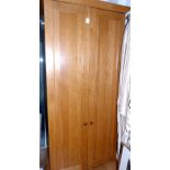 Contemporary oak free standing larder, the twin panel doors opening to reveal fitted shelves to