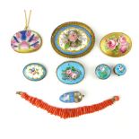 Collection of ceramic plaque brooches, lapel/button holes and pendants, and a branch coral bracelet.