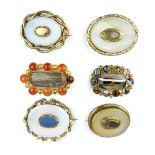 Two agate decorated brooches and four late 19th/early 20th C opaque glass brooches. (6)
