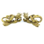 Pair of Chinese brass ornaments, fashioned as dragons, 21cm