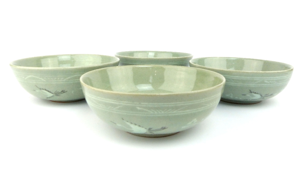 A set of four Korean porcelain footed bowls, the crackle celadon glazed bodies decorated with frieze