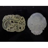 Two chinese jade pendants of dragons one with foliate carving, the other with two dragons around