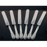 Six late 19th century German white metal dinner knives, marked 800, with foliate decoration, (6)