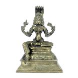 White metal South East Asian figurine of seated deity, raised on lotus base,19cm h.