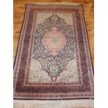 Indian part silk rug, decorated with floral spandrels and central teardrop medallion,