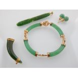 Jade 'claw' brooch, jade tribal effigy pendant, and Chinese jade bracelet and earrings.