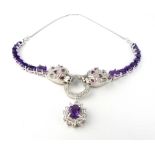 Silver, cubic zirconia and amethyst double panthers' head necklace.