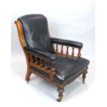 Victorian walnut and black leather upholstered arm chair, the open arms with vase shaped supports,