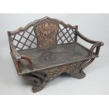 Asian carved twin seat bench, mid 20th C, shaped back rail with lattice work and central carved