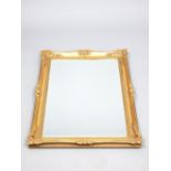 Gilt painted mirror of French influence, scroll and shell pierced decoration, bar and ribbon