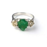 18ct white gold, emerald and diamond ring with central heart shaped stone.