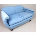 Late Edwardian upholstered sofa, covered in a pale blue fabric with C-scroll arms, two cushions