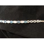 Silver, blue topaz and cubic zirconia bracelet set faceted oval and square cut stones