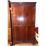 Early 20th century mahogany wardrobe, the dental moulded cornice above a pair of panel doors