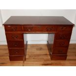 Reproduction mahogany pedestal desk fitted with eight drawers on plinth foot, 120cm W