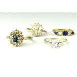 9 ct yellow gold blue and white five stone dress ring, a 9 ct cluster ring, a white metal