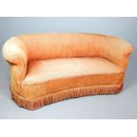 Chesterfield style upholstered settee, covered with an orange fabric and fringe to base, 162cm w