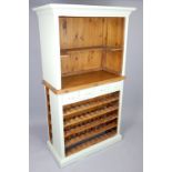 Painted pine wine dresser, open wine / bottle racks over drawers and open shelving, with further