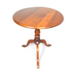Victorian mahogany tripod table by Shoolbred, with circular tilt top on baluster pillar, block