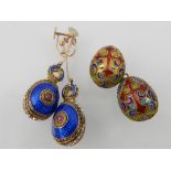 Pair of enamel egg earrings and two multi-coloured enamel decorated egg pendants. (3)