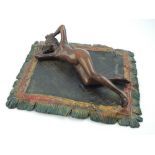 Austrian style cold painted bronze, modelled in the form a woman reclining on a Persian rug, 19cm w