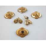 Selection of brooches and earrings with scallop decoration.