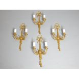 Set of four twin arm wall sconces of Louis XVI style, ribbon finial, acanthus scrolls and tassels,