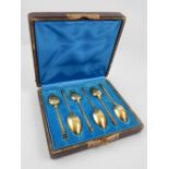 Early 20th C cased silver gilt teaspoons, trailing decoration, gilt tooling to case.