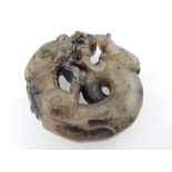 Chinese jade pendant, coiled dragon nose to nose with a rat, 5cm dia.