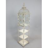 Victorian style aged metal tall floor standing lantern of arched square form with three tier base