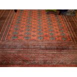 Bokhara red ground rug, multi elephant pad medallions to centre, within reticulated borders,