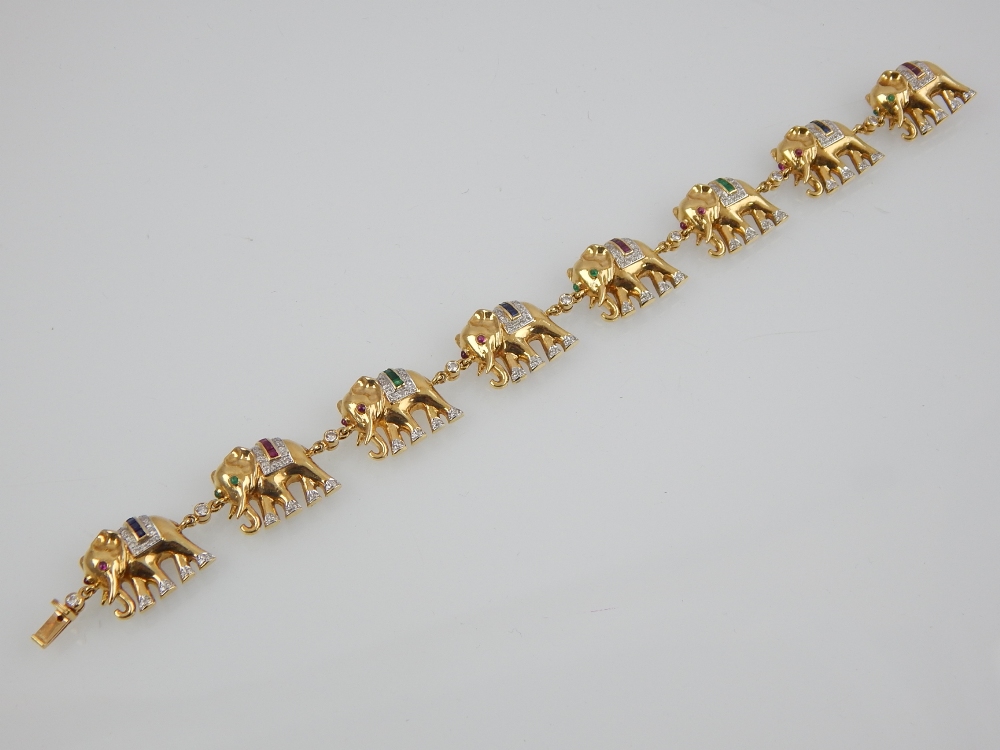 A diamond, ruby, emerald and sapphire set bracelet in 18ct yellow.