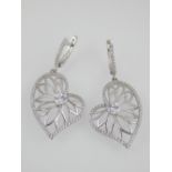 Pair of contemporary silver and white stone earrings of asymmetrical leaf form.