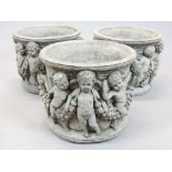 Set of three Victorian style circular reconstituted stone garden planters moulded with bands of