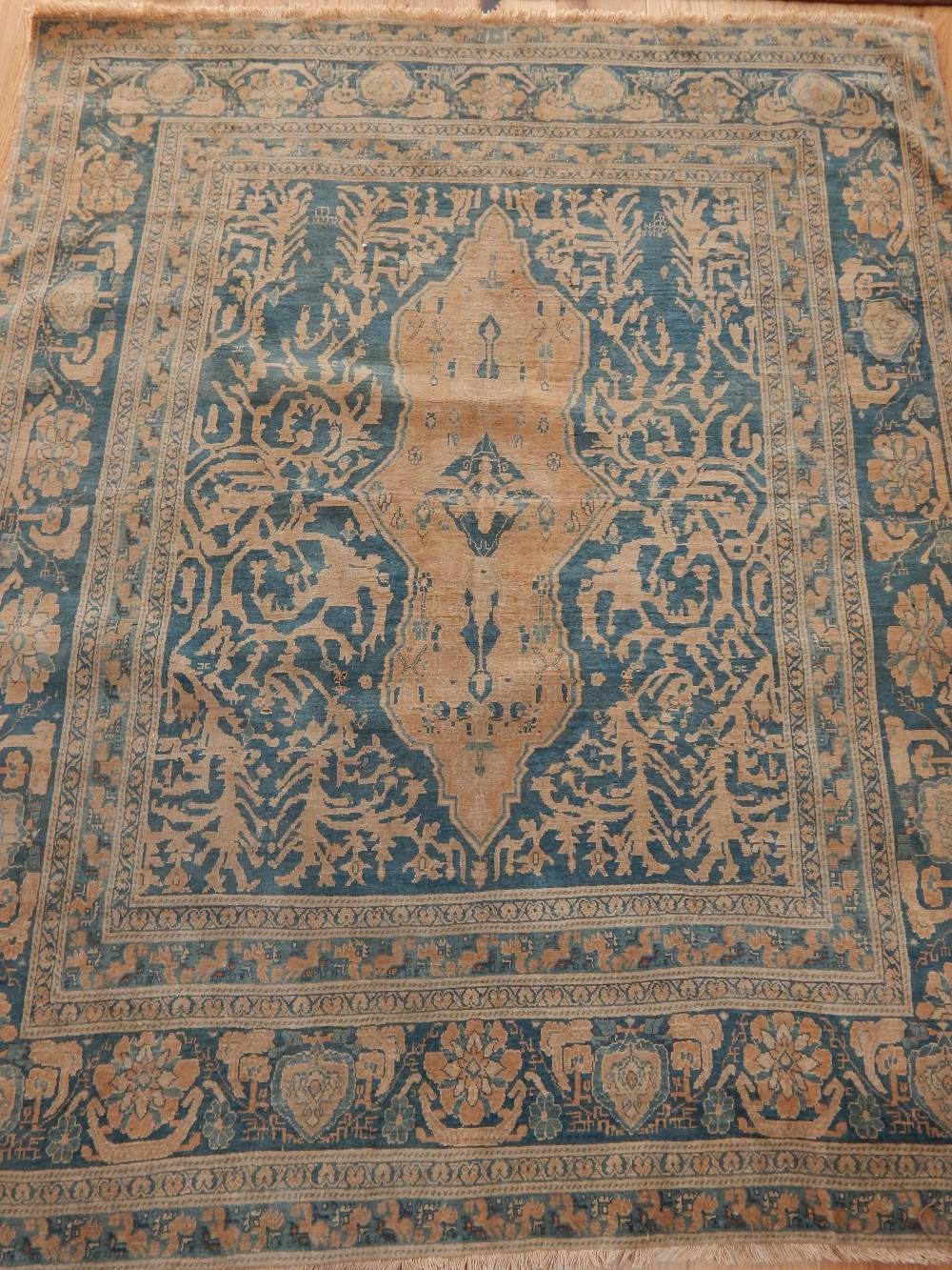 North West Persian part silk rug, traditional floral design over blue ground, fringed (cut down),