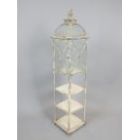 Victorian style aged metal tall floor standing lantern of arched square form with three tier base