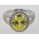 Silver cubic zirconia and yellow stone dress ring.