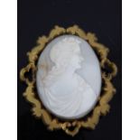 Shell cameo brooch depicting a classical goddess on a pale shell,