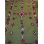 Brazilian rug, geometric designs on a green ground, 240cm w.