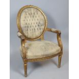 Gilded elbow chair, bead and ribbontwist edges, rose carving surmount, button back and padded arms.