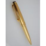 Gilt ballpoint pen with engine turned body.