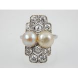 An antique Art Deco diamond and natural pearl ring circa 1920 in platinum.