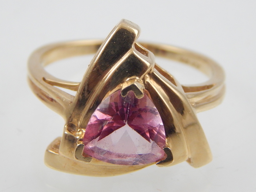 9ct yellow gold pink topaz ring the trillion cut stone in triangular mount.