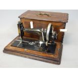 Late 19th century German Silerberg cast iron sewing machine in inlaid walnut case.