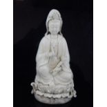 Chinese Guyliu goddess, holding a ruyi and seated upon a lily pad, impress marks to back, 26cm h.