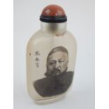 Chinese Peking glass snuff bottle, decorated with male to front and script to other side.