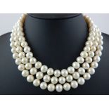 A three strand cultured pearl necklace with a gold clasp, the pearls, of an approx average of 9.