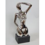 Contemporary silvered ceramic sculpture, female nude on rectangular ebonised plinth, 75cm H.